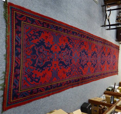 Lot 1190 - An Ushak runner, central/west Anatolia, the raspberry field with a column of hooked medallions...