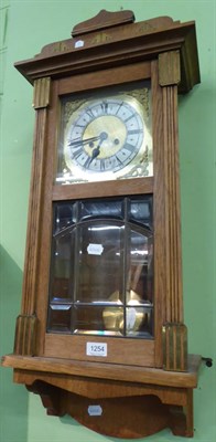 Lot 1254 - An oak striking wall clock