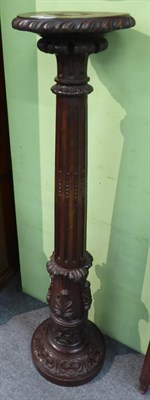 Lot 1255 - A 19th century mahogany torchere with acanthus leaf and gadrooned carving and fluted standard