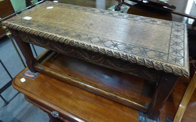 Lot 1275 - A carved oak stool