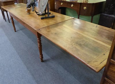 Lot 1292 - A 19th century French draw leaf farmhouse table, 13' 3"; (400cm) extended