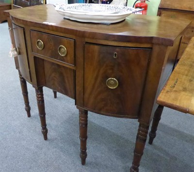 Lot 1294 - A Georgian mahogany breakfront sideboard