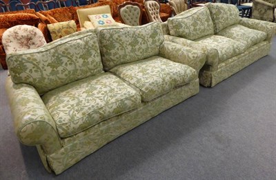 Lot 1302 - A feather filled two piece suite comprising two two-seater sofas