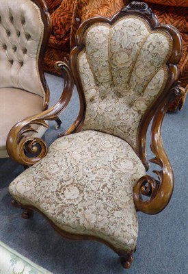 Lot 1303 - A Victorian button back armchair with carved mahogany frame