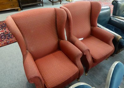 Lot 1310 - A pair of wing back armchairs