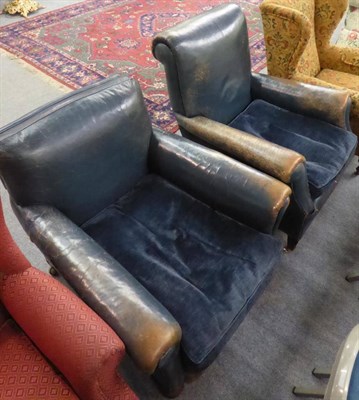 Lot 1311 - Two early 20th century blue hide-upholstered club armchairs, with feather-filled, loose...