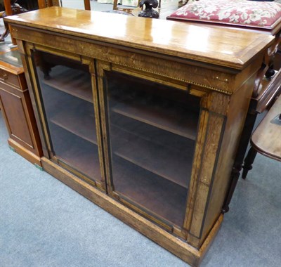 Lot 1335 - A late Victorian inlaid oak low bookcase fitted with two shelves