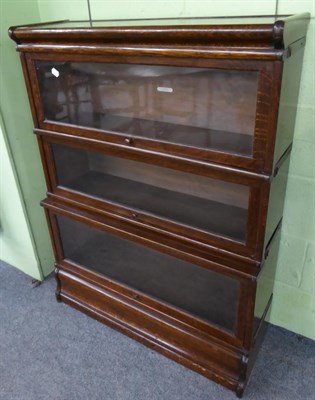 Lot 1353 - A three tier glazed oak bookcase by J & D Robinson, Leeds