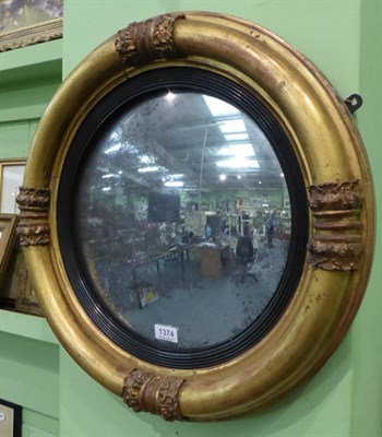 Lot 1374 - An early 19th century giltwood circular wall mirror