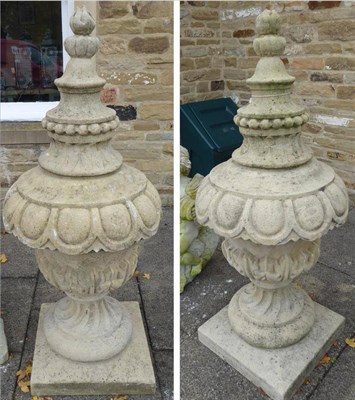 Lot 1380 - A matching pair of garden urns with raised finial, egg and dart frieze on pedestal basees,...