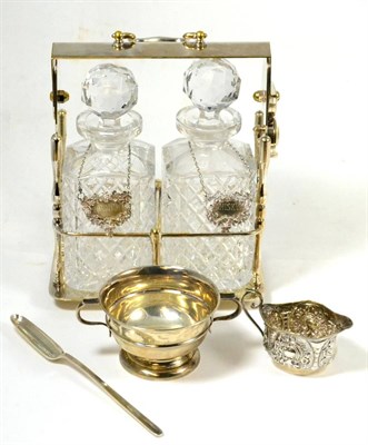Lot 29 - A Victorian silver cream, silver twin-handled cup, a two bottle silver plated Tantalus with...