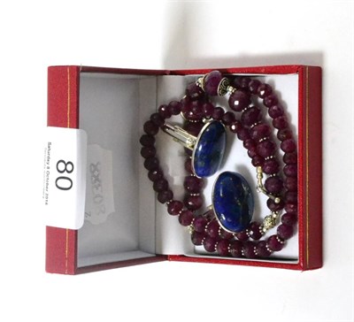 Lot 80 - An Indian faceted red bead necklace together with a pair of lapiz lazuli cufflinks