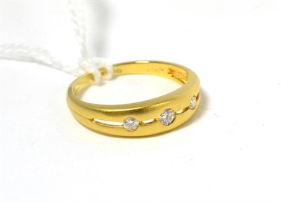 Lot 96 - An 18ct gold matt finish diamond three stone ring