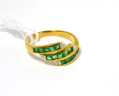 Lot 105 - An emerald and diamond three row ring stamped 750