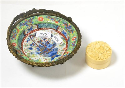 Lot 125 - Japanese ivory circular box and cover and a clobbered Chinese blue and white plate in a metal frame