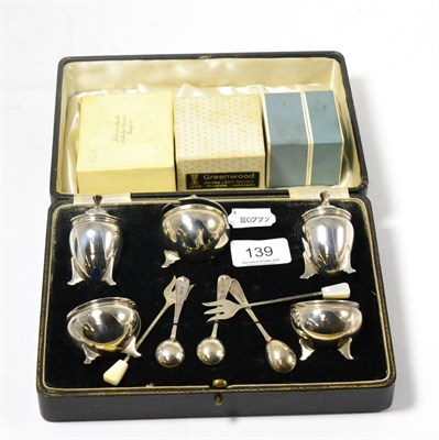 Lot 139 - A cased silver cruet set, Birmingham 1933; together with three boxed napkin rings
