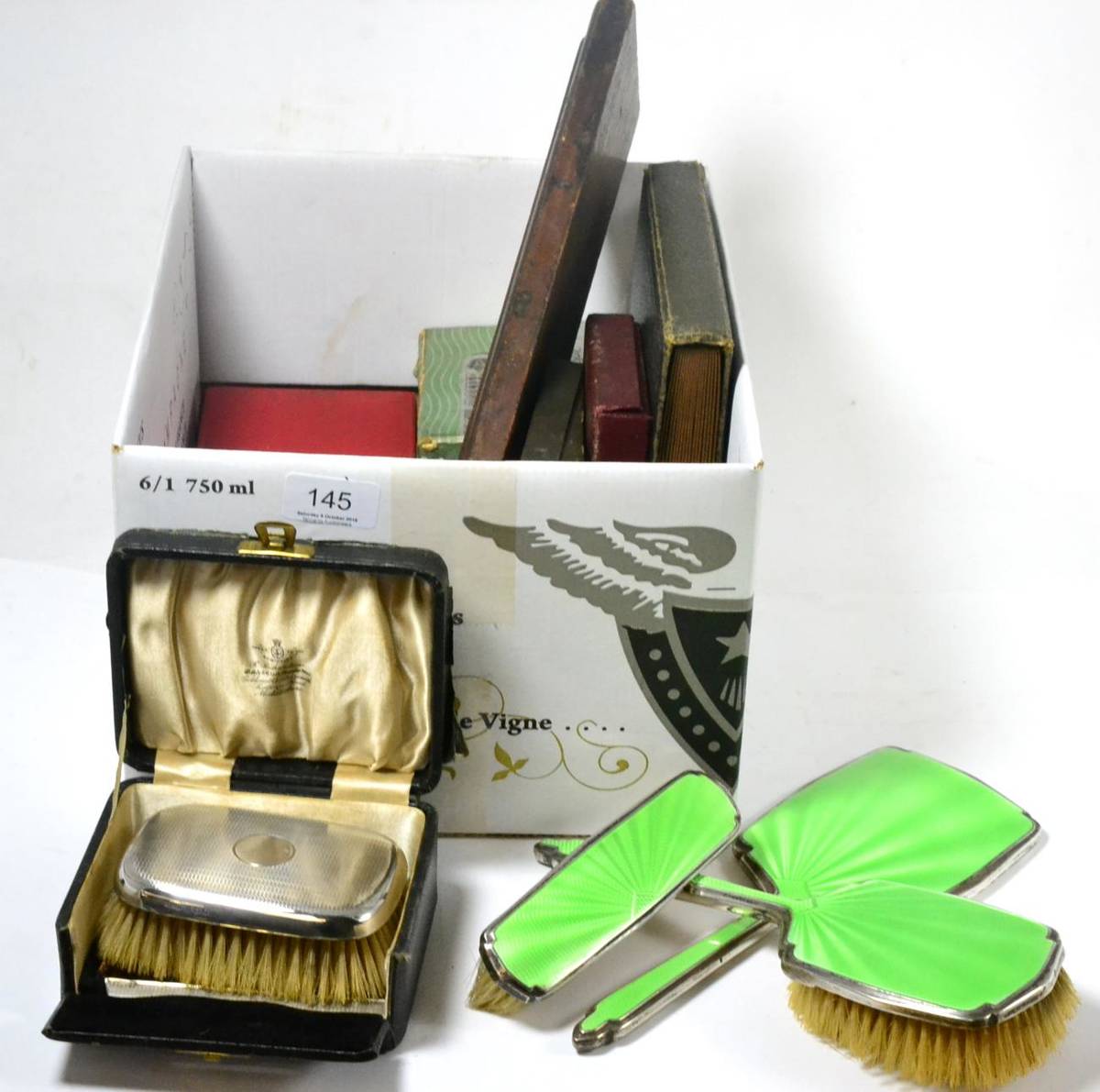 Lot 145 - Three piece silver and enamel dressing sets, including two brushes and a hand mirror, cased...