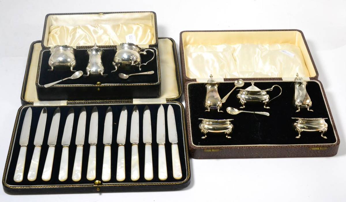 Lot 146 - Two cased silver condiment sets, cased set of twelve dessert knives with mother-of-pearl handles
