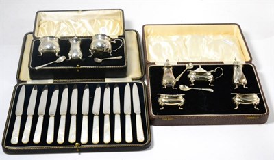 Lot 146 - Two cased silver condiment sets, cased set of twelve dessert knives with mother-of-pearl handles