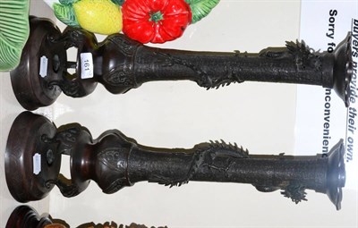 Lot 161 - A pair of Japanese bronze candlesticks, cast with entwined dragons in relief