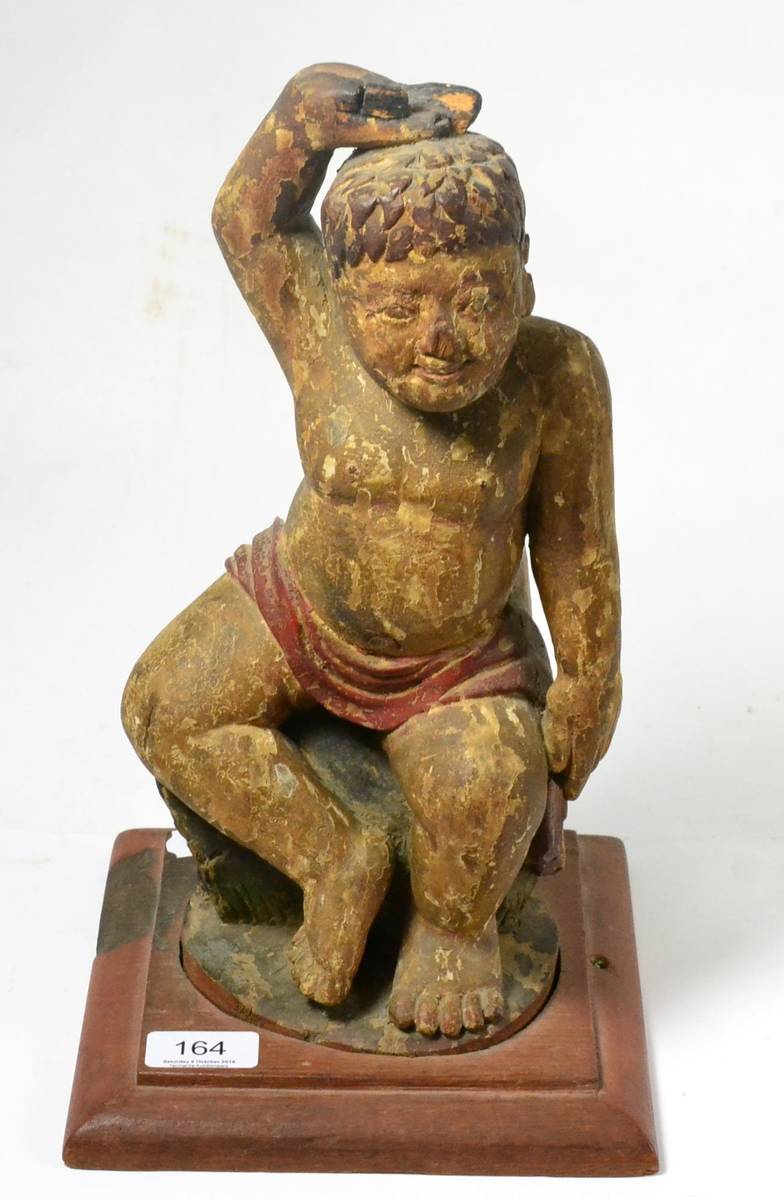 Lot 164 - A Burmese wooden painted figure