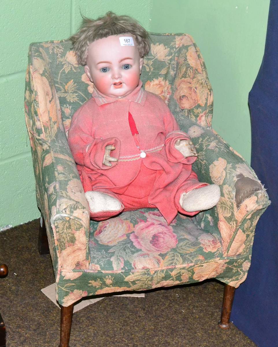 Lot 167 - A bisque head doll together with a child's winged arm chair