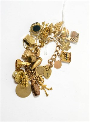 Lot 179 - A 9ct gold charm bracelet with various charms