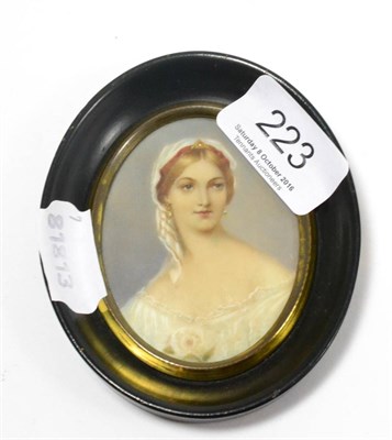 Lot 223 - A French portrait miniature of a pretty young girl, in an ormolu easel back oval frame