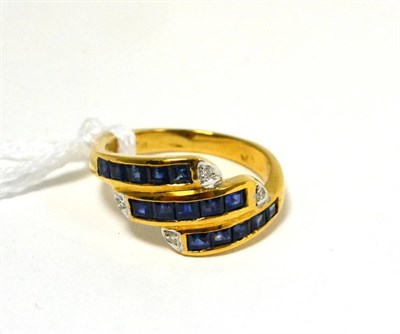 Lot 233 - A sapphire and diamond three row ring stamped '750'