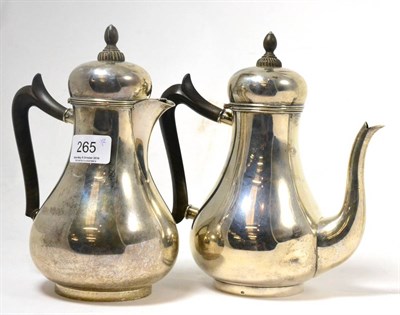 Lot 265 - An early 20th century Dutch silver teapot and hot water jug, of baluster shape with wooden knop and