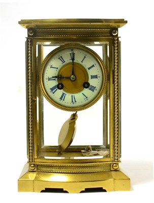 Lot 267 - A brass four glass striking mantle clock with bowed front panel, the movement signed