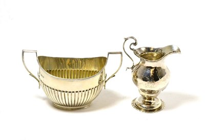 Lot 271 - A silver twin handled sugar bowl and a Georgian silver cream jug (2)