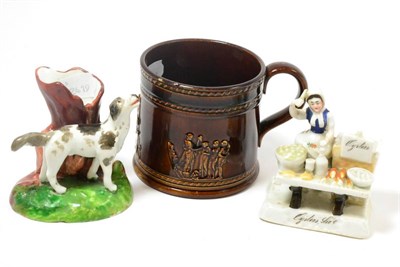 Lot 275 - A 19th century porcelaneous posy vase as a gun dog, a treacle glaze mug and a German fairing...