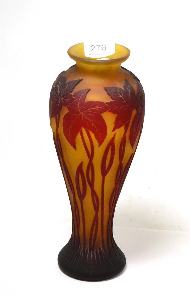 Lot 276 - Akra cameo glass vase, decorated with leaves on an amber ground