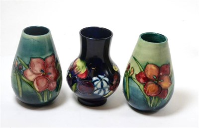 Lot 282 - A Walter Moorcroft Orchid and Spring Flowers pattern vase, on a blue ground, impressed factory...