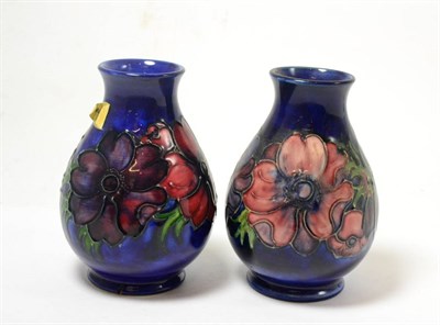Lot 283 - Two Walter Moorcroft Anemone pattern vases, on blue grounds, impressed factory marks, 14cm (one...
