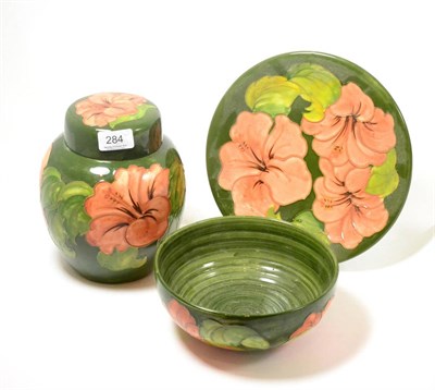 Lot 284 - A Walter Moorcroft Coral Hibiscus pattern ginger jar and cover, on a green ground, impressed...