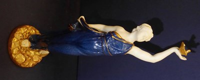 Lot 285 - A Royal Worcester figure of Liberty modelled as a gowned maiden holding aloft a dove, with puce...