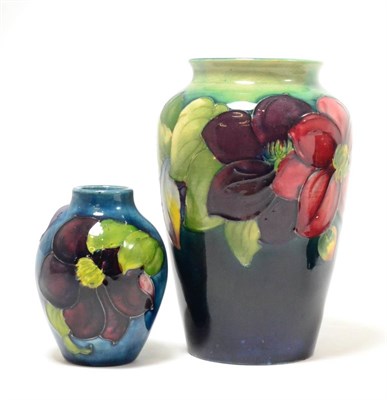 Lot 288 - A Walter Moorcroft Clematis pattern vase, on a blue wash ground, impressed factory marks and...