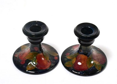 Lot 290 - A pair of William Moorcroft Pomegranate pattern squat candlesticks, impressed factory marks,...