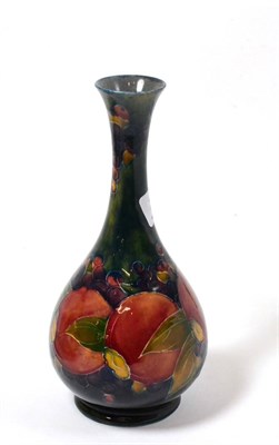 Lot 292 - A William Moorcroft Pomegranate pattern vase, on a blue ground, impressed factory marks and...
