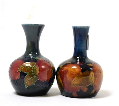 Lot 294 - Two William Moorcroft Pomegranate pattern vases, on blue grounds, impressed factory marks, 10cm...