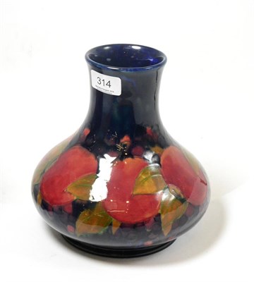 Lot 314 - A William Moorcroft Pomegranate pattern vase, on a blue ground, impressed factory marks and...