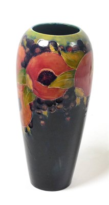 Lot 316 - A William Moorcroft Pomegranate pattern vase, on a blue ground, impressed factory marks, green...