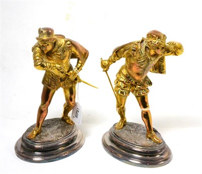 Lot 318 - A pair of gilt brass figures of Elizabethan swordsmen, late 19th/early 20th century, on silver...