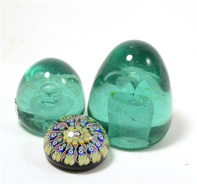 Lot 333 - Two Stourbridge green glass dumps and a millefiori paperweight centred by a gavel (3)
