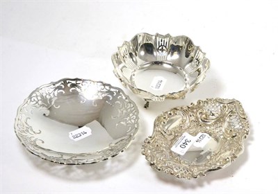 Lot 340 - Three various pierced silver dishes, one raised on three feet (3)
