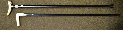 Lot 350 - Two late 19th/early 20th century silver mounted ebonised walking canes with ivory handles