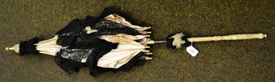 Lot 351 - Late 19th century carved ivory handled parasol, with silk and black lace mount (a.f.)