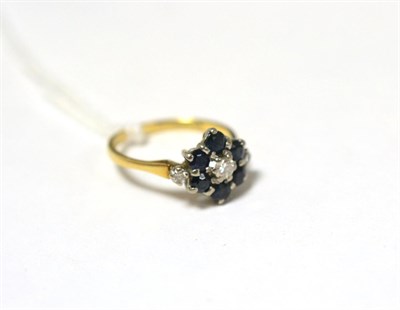 Lot 379 - An 18ct gold diamond and sapphire cluster ring